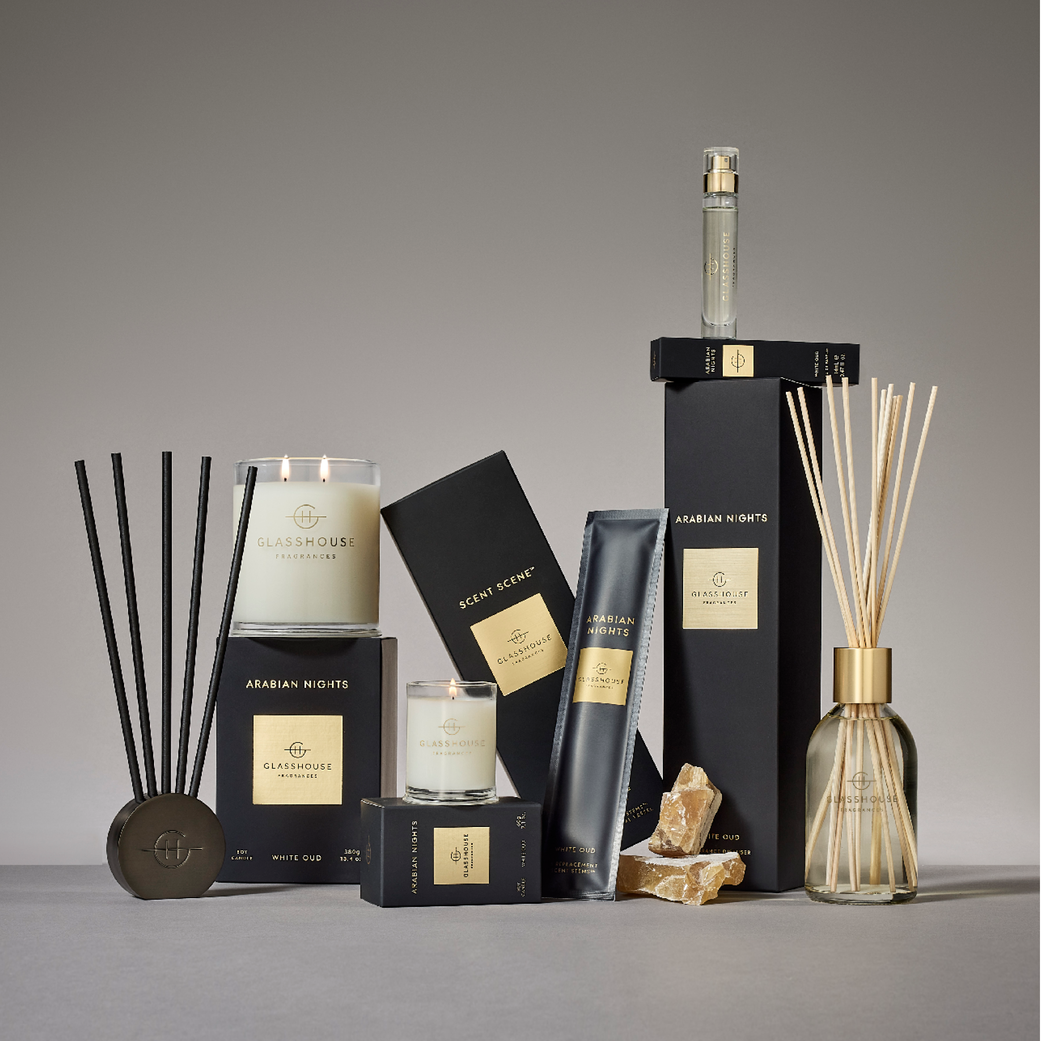 Collection of Glasshouse Fragrances Arabian Nights home fragrance products including candles, diffusers, and boxes.