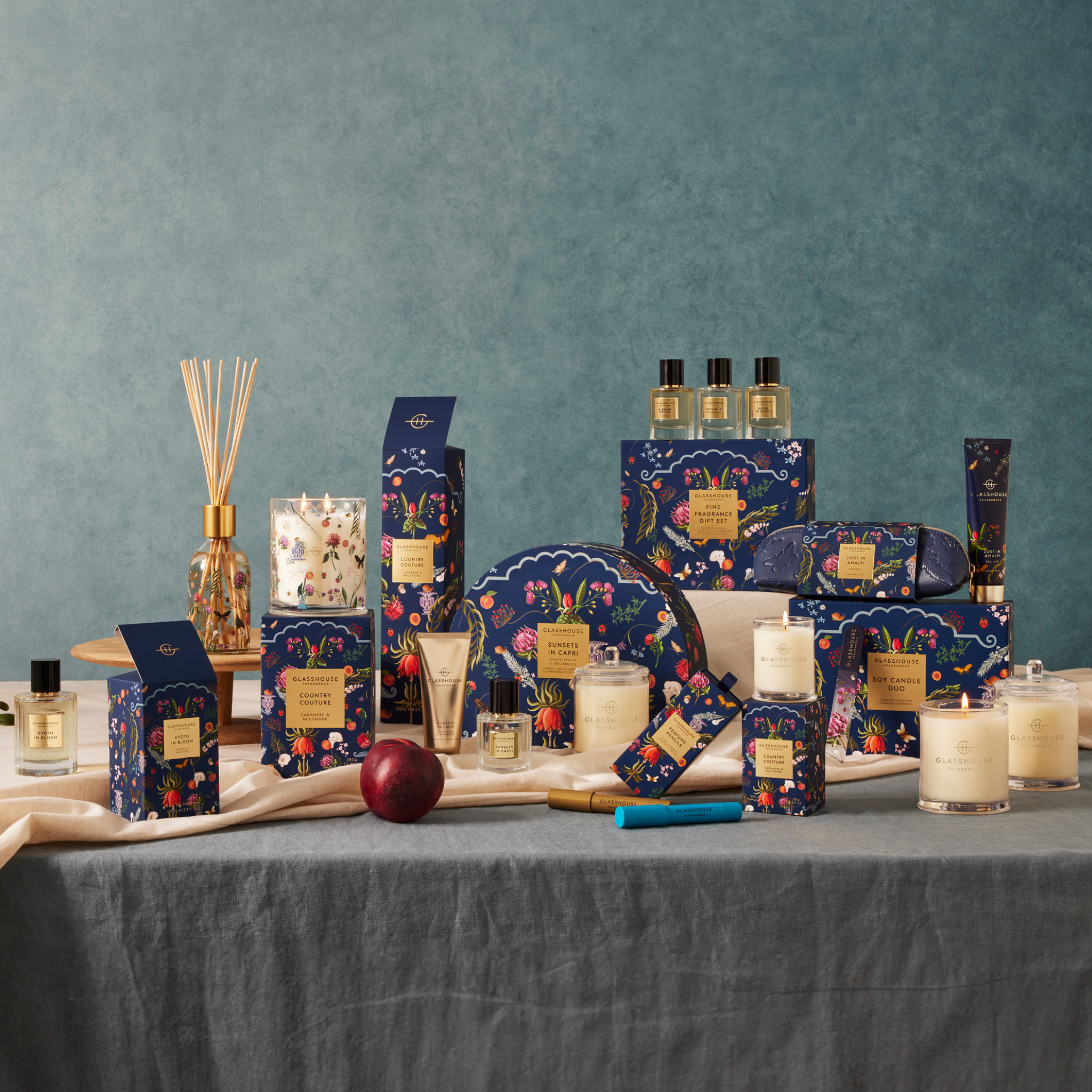 Glasshouse Fragrances Country Couture Fragrance Family image on table with fruit.